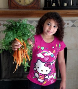 My youngest with our first carrot harvest.  Carrots have never tasted so sweet!